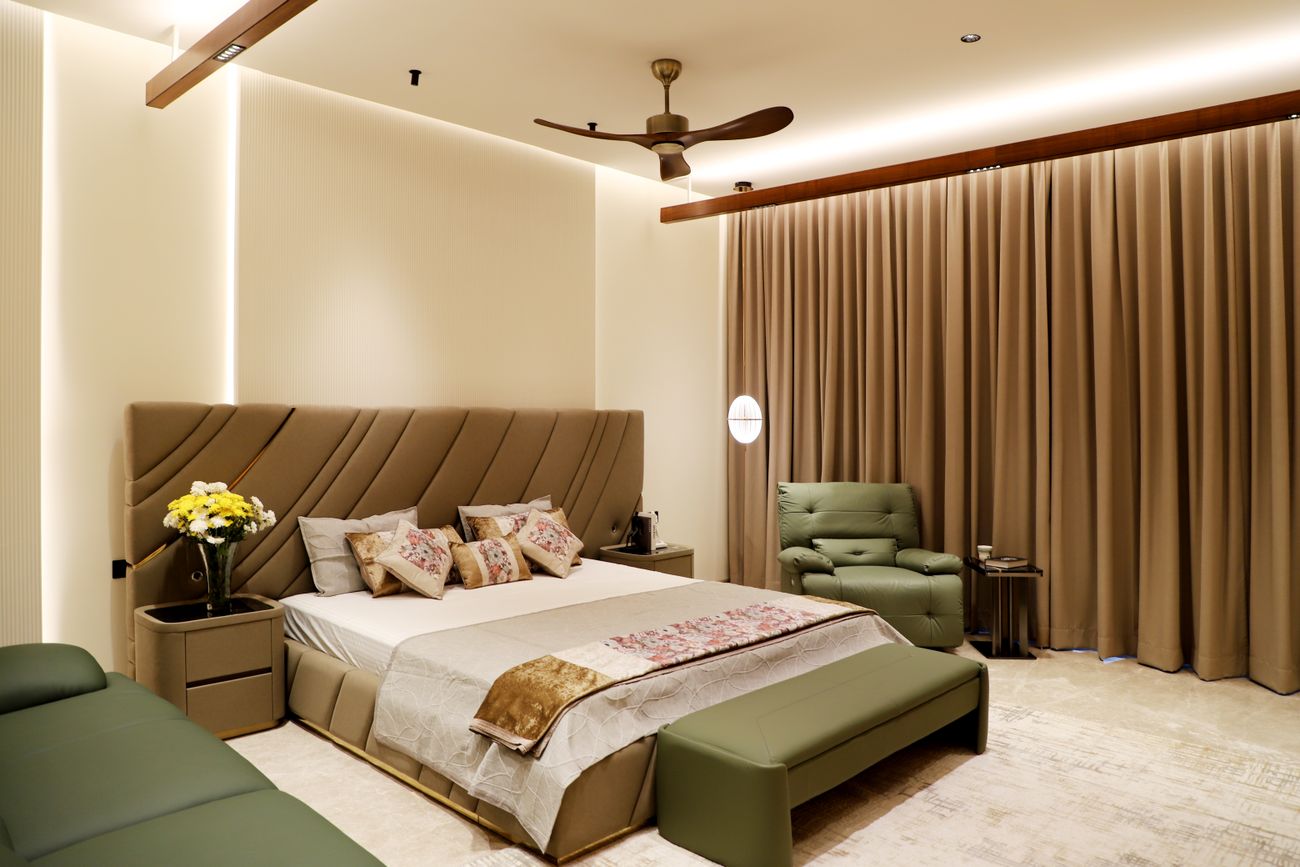 A warm, modern hotel bedroom with timber accents and a ceiling fan