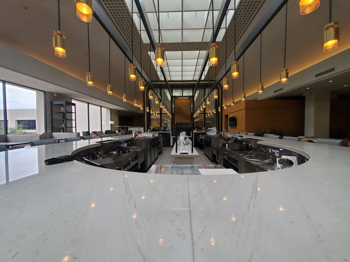 A long marble bar under pendant lights