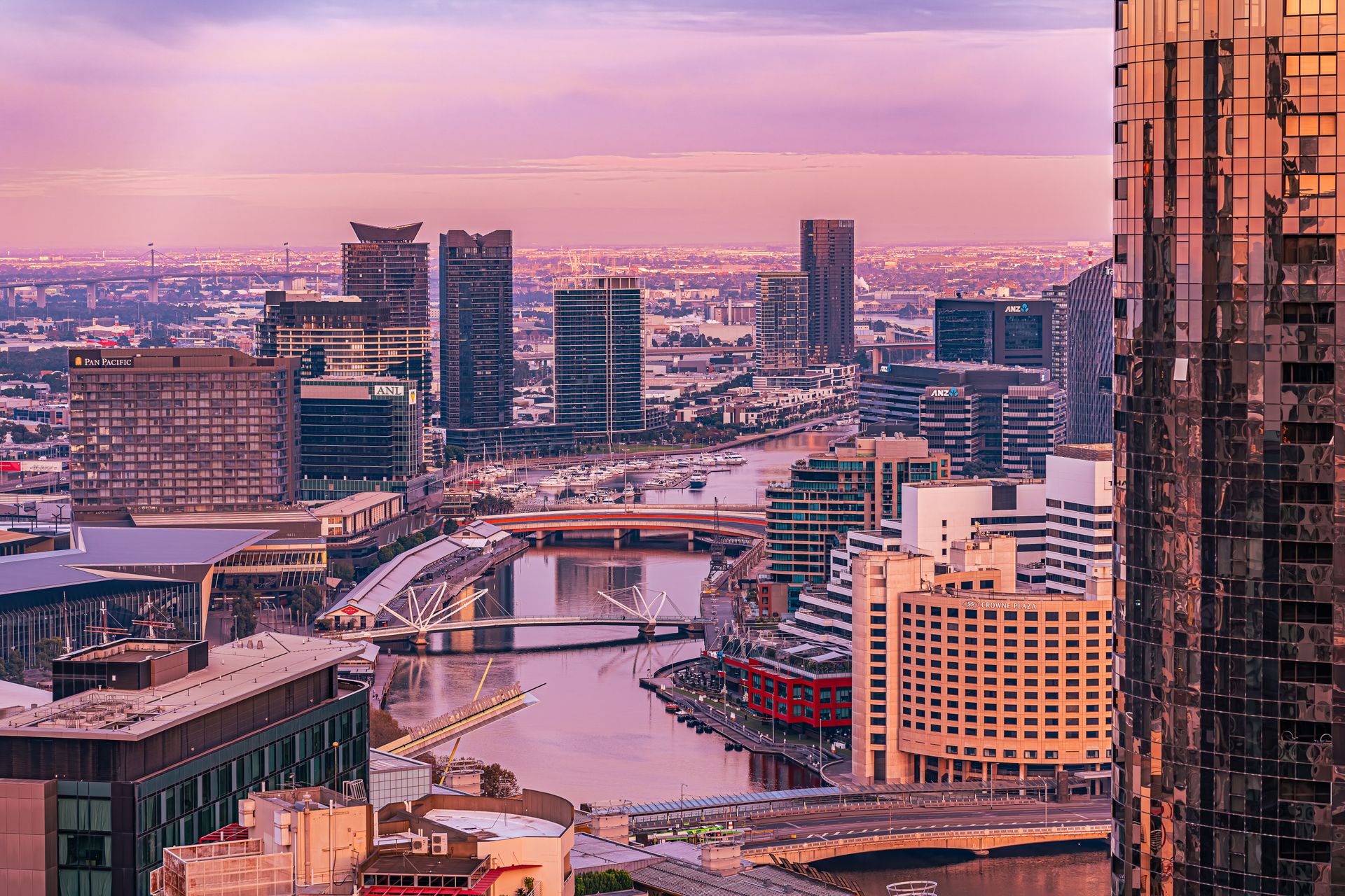 Melbourne at dusk, looking over South Wharf, the Yarra and its bridges