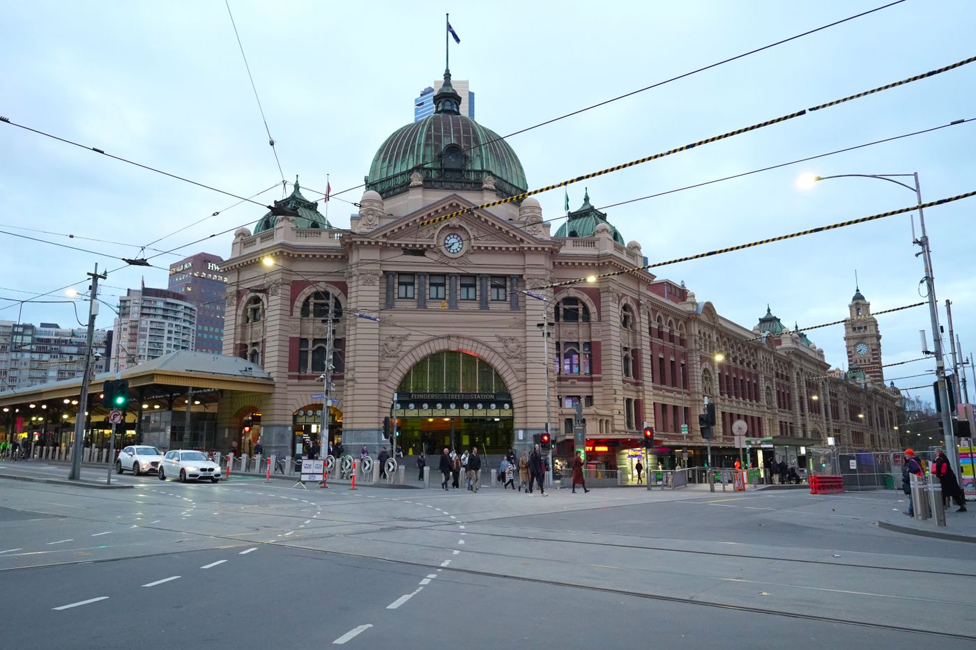 Flinders Street Station's domed facade with tram lines in the foreground