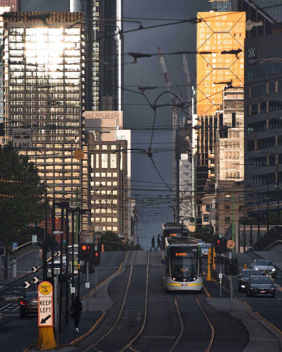 A Melbourne tram on a city street lined with towers
