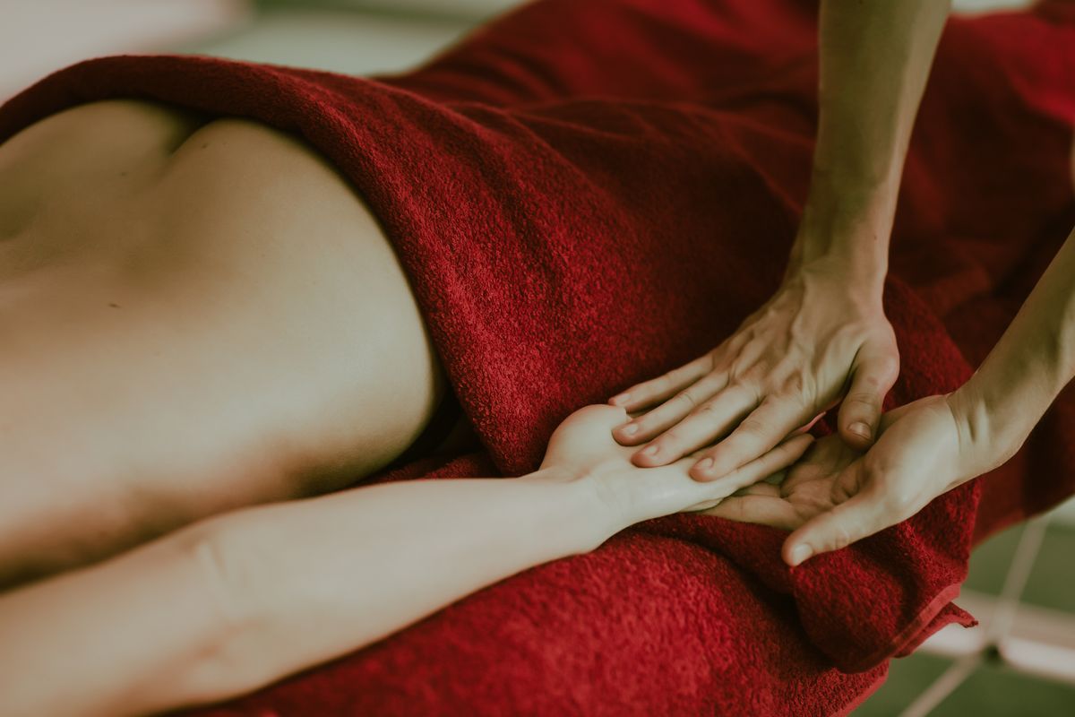 A massage treatment, with a guest wrapped in a towel